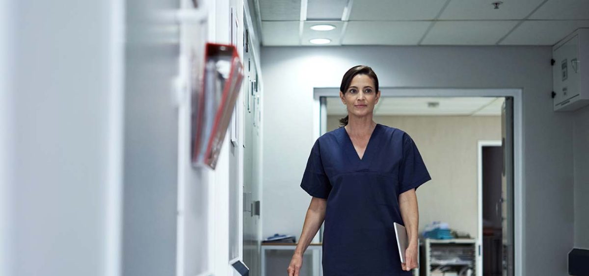 nurse walks on hallways seems worried about her employment protections