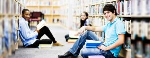 students sitting on library hallway